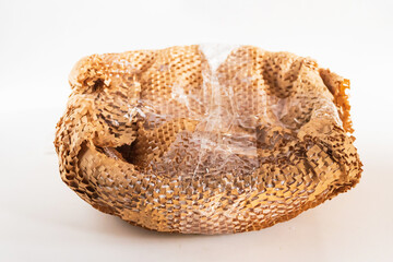 Obraz premium A textured view of crumpled packaging foam, showcasing its unique patterns and folds against a clean white background.