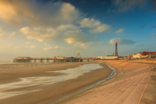 Beautiful landscape of Blackpool beach with the tower and ferris wheel at sunset. United Kingdom