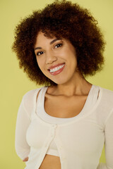 A young African American woman with curly hair radiates happiness while standing confidently in her underwear.