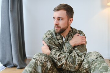 Fototapeta premium Portrait of middle aged sad, desperate military man. PTSD concept. Horizontal shot