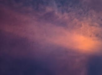 The beauty of the evening sky with clouds in shades of pink, purple, and orange, created by the sunlight casting a stunning gradient of colors on the horizon, evoking a peaceful and magical atmospher