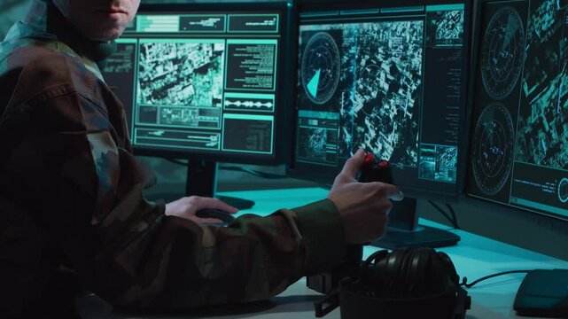 Military soldier operating advanced technology in a command center.