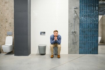 Man sitting on the toilet at the building market