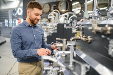 Man chooses a products in a sanitary ware store