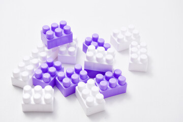 Purple and white toy blocks on white background, educational toys for children