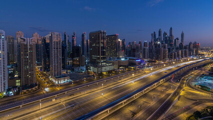 Fototapeta premium Dubai Marina skyscrapers aerial top view before sunrise from JLT in Dubai night to day timelapse, UAE.