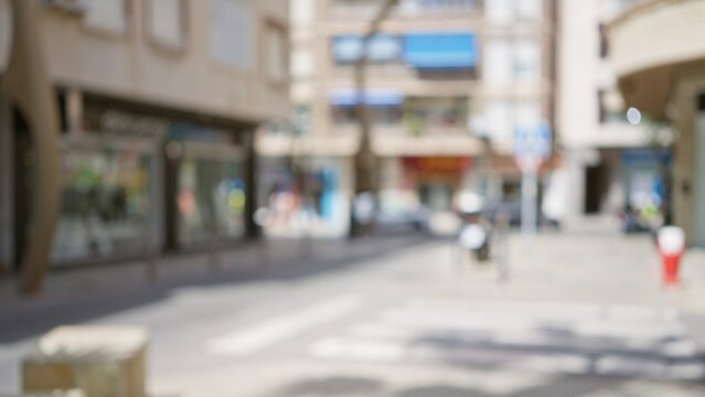Blurred background of a city street with out of focus buildings and a bokeh effect in an outdoor setting