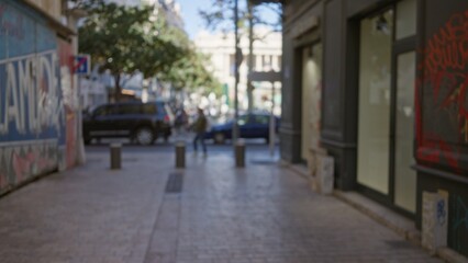 Obraz premium City street in marseille, france with a blurry, defocused perspective and street art on walls, capturing motion of a man walking outdoors on a clear day.