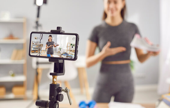 Close up mobile device filming fit healthy woman model making commercial social media marketing ecommerce sport shoes brand collaboration integration athletic training exercise footwear video review