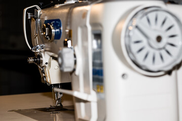 sturdy modern industrial sewing machine used for sewing heavy materials in textile manufacturing