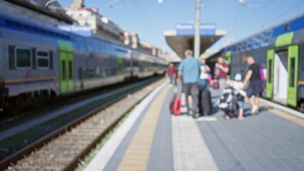 Blurred people at busy railway station platform with bright trains, illustrating travel and transit with blue sky background and focus on commuter movement.