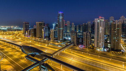 Dubai Marina skyscrapers aerial top view before sunrise from JLT in Dubai night to day timelapse, UAE.