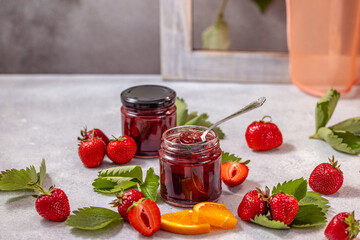 Homemade strawberry jam with fresh strawberries and orange slices