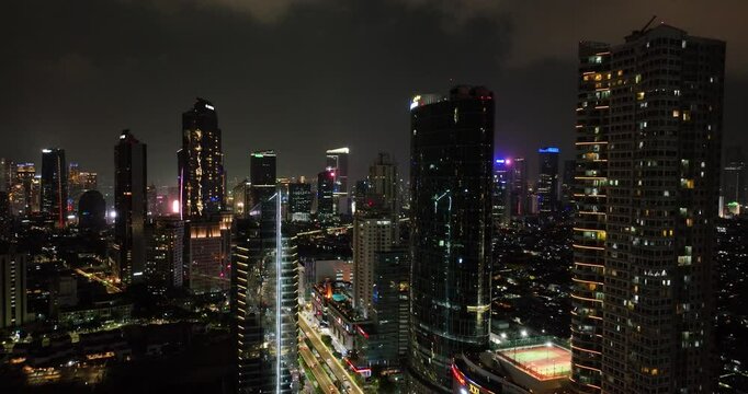 Aerial view of night panorama of Jakarta city with skyscrapers.