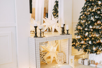 Christmas interior in a luxurious golden style with garlands in the form of stars and a mirror. Background for New Year wallpapers and postcards.