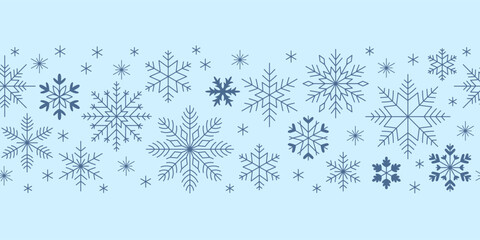 Snowflakes seamless border. Element for Christmas and New Year design. Crystal geometric blue snowflakes. Light blue background.