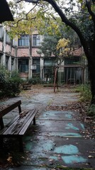 Obraz premium Neglected school courtyard, cracked concrete path, overgrown with weeds, broken swings, empty benches, faded remnants of childhood, abandoned outdoor school space