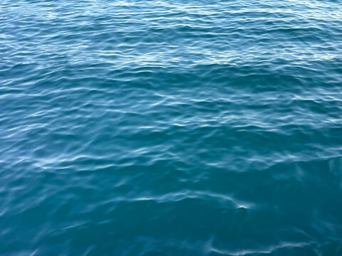 Blue water ripples aqua surface background. 