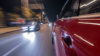 Naklejka premium Drivelapse from side of car moving on a night avenue in city timelapse hyperlapse