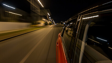 Drivelapse from side of car moving on a night avenue in city timelapse hyperlapse