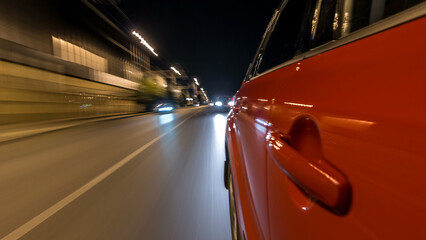 Fototapeta premium Drivelapse from side of car moving on a night avenue in city timelapse hyperlapse