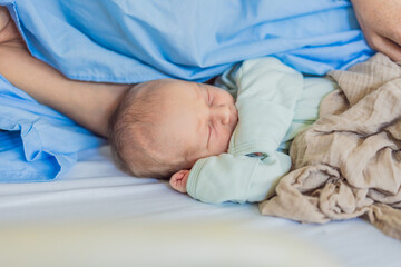 A baby lies with the mother after childbirth, resting peacefully. The serene moment captures the...