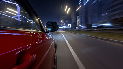Obraz premium Drivelapse urban look from fast driving car at a night avenue in a city timelapse hyperlapse