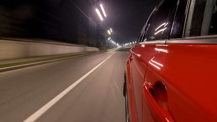 Drivelapse urban look from fast driving car at a night avenue in a city timelapse hyperlapse