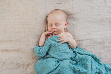 The baby is sleeping peacefully in his cozy nest. Newborn photo session captures the serene innocence and warmth of early moments