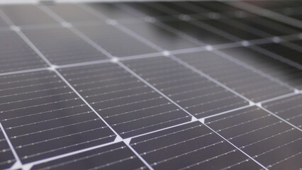 Photovoltaic solar panel extreme close up. Close-up of modern photovoltaic solar battery panels. Rows of sustainable energy solar panels installed on terrace. Solar panels on roof top. Panels at home