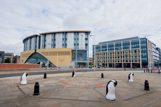 Dundee Scotland: 4th Aug 2024: Dundee Discovery ship museum exterior with penguins. Dundee train station in background