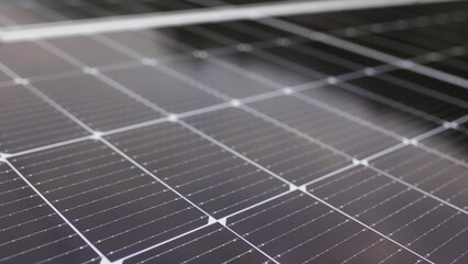 Close-up of modern photovoltaic solar battery panels. Rows of sustainable energy solar panels installed on terrace. Solar panels on roof top. Panels at home. Photovoltaic solar panel extreme close up.