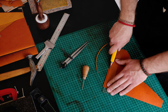 Crafting Leather Goods, Artisan at Work Cutting Leather