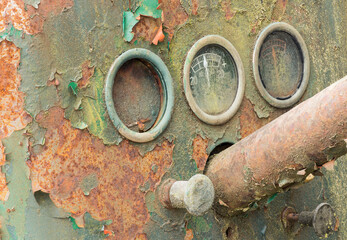 Rusted machinery dials in a forgotten junkyard setting