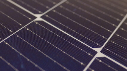 Macro shoot of modern photovoltaic solar battery panels. Ecology and environment protection concept. Renewable green energy. Solar panels close-up. Solar panels slow motion. Solar panels moving shot
