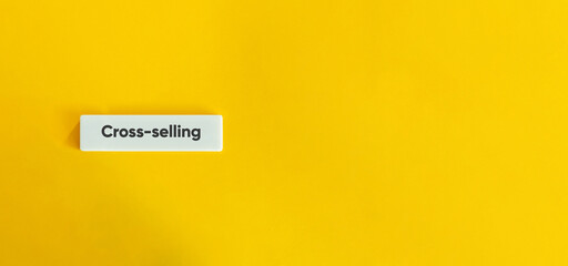 Cross-selling Term. Text on Block Letter Tile on Yellow Background. Minimal Aesthetic.