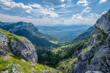 A scenic view from a mountaintop overlooking a lush valley in the French Alps A breathtaking vista of a valley below from a high ridge