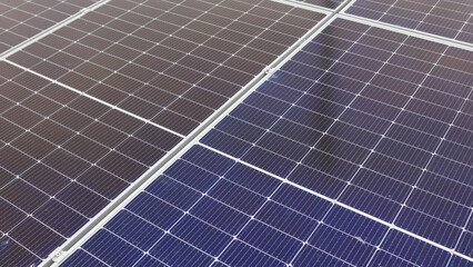 Close-up of modern photovoltaic solar battery. Rows of sustainable energy solar panels installed on farmland meadow rural field. Concept for ecology. Solar Panel Array