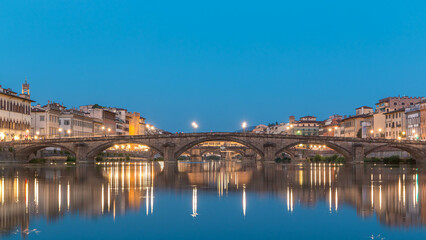 Obraz premium Ponte Alla Carraia and Santa Trinita Holy Trinity Bridge day to night timelapse over River Arno in Florence