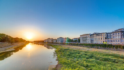 Obraz premium Sunset skyline view of Florence City, housing, buildings and Arno River. Colorful sky in Italy