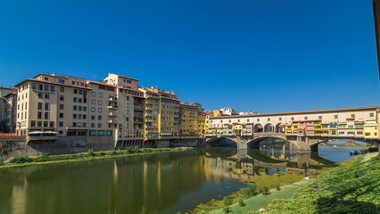 The Ponte Vecchio on a sunny day timelapse hyperlapse, a medieval stone segmental arch bridge over the Arno River, in Florence, Italy