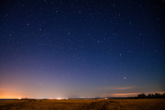 A beautiful night sky full of countless stars shining over a field
