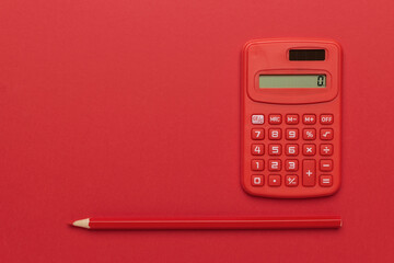 Red Calculator and Pencil on Red Background: Minimalist Office Supplies in Bold Color