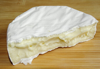 Camembert cheese on wooden background
