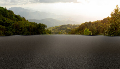 Asphalt parking lot or road with mountain background in morning or evening, backdrop for product display, black rough surface, cars, technology, modern equipment, surface for automotive showroom. © 100yDesign