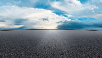 Asphalt parking lot or road with clouds blue sky clouds background, black rough surface product display backdrop, car, technology, modern equipment, automotive showroom texture. © 100yDesign