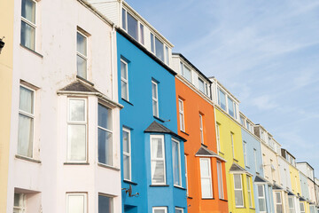 Colorful and vibrant generic multistorey apartment buildings against a bright blue sky