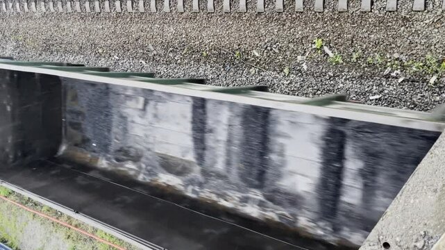 Vertical video of empty rail cars moving on railway in summer