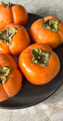 Close-up of several ripe persimmons.  Shot on mobile device.