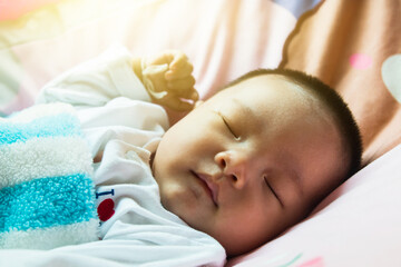 face of baby who is sleeping on bed